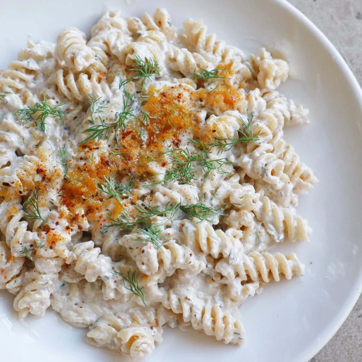 Steaming bowl of Turkish Yogurt Pasta, with creamy white yogurt sauce and vibrant red spiced butter.