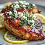 Juicy marinated Greek Chicken with Lemon and Feta served alongside a crisp salad, perfect for a healthy dinner.