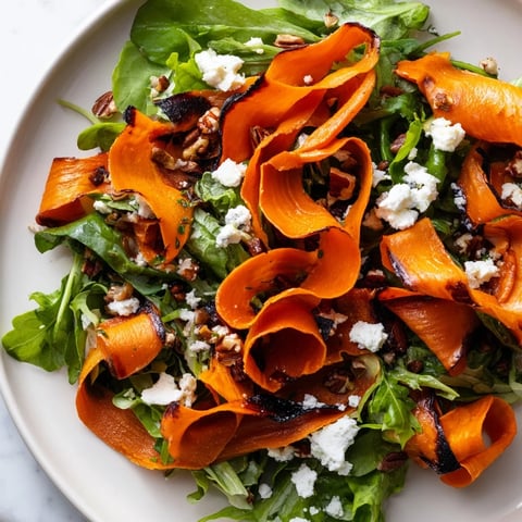 Golden roasted carrot ribbons, tender and lightly caramelized, layered over a bed of fresh mixed greens in this vibrant Roasted Carrot Ribbon Salad.