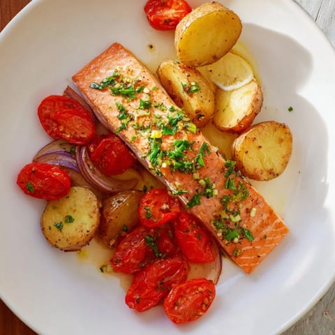 One-Tray Baked Trout with herbs, garlic and lemon, served alongside tender roasted potatoes.