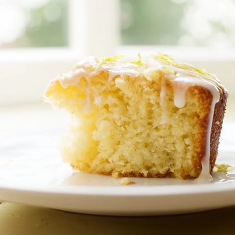 Golden, baked Lemon Yogurt Cake, emanating a sweet lemon aroma, perfect for dessert tonight.