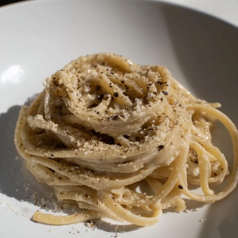 Steaming bowl of Lazy Girl Three-Ingredient Pasta, tossed in a buttery Parmesan sauce, a quick weeknight dinner.