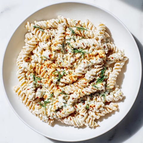 Close-up of Turkish Yogurt Pasta, showcasing perfectly cooked pasta coated in a garlicky yogurt sauce.