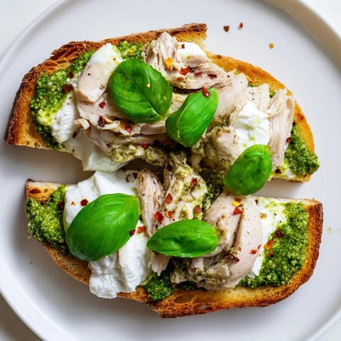 Pesto Chicken Burrata Toast features toasted bread layered with tender chicken and melty burrata.  
