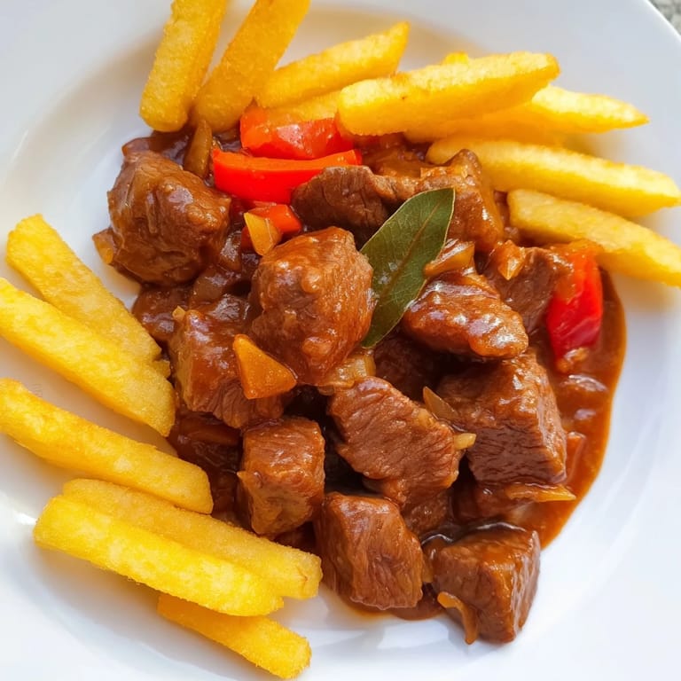 Crispy potato strips atop a savory Czech Goulash Potato, a comforting and robust meal.